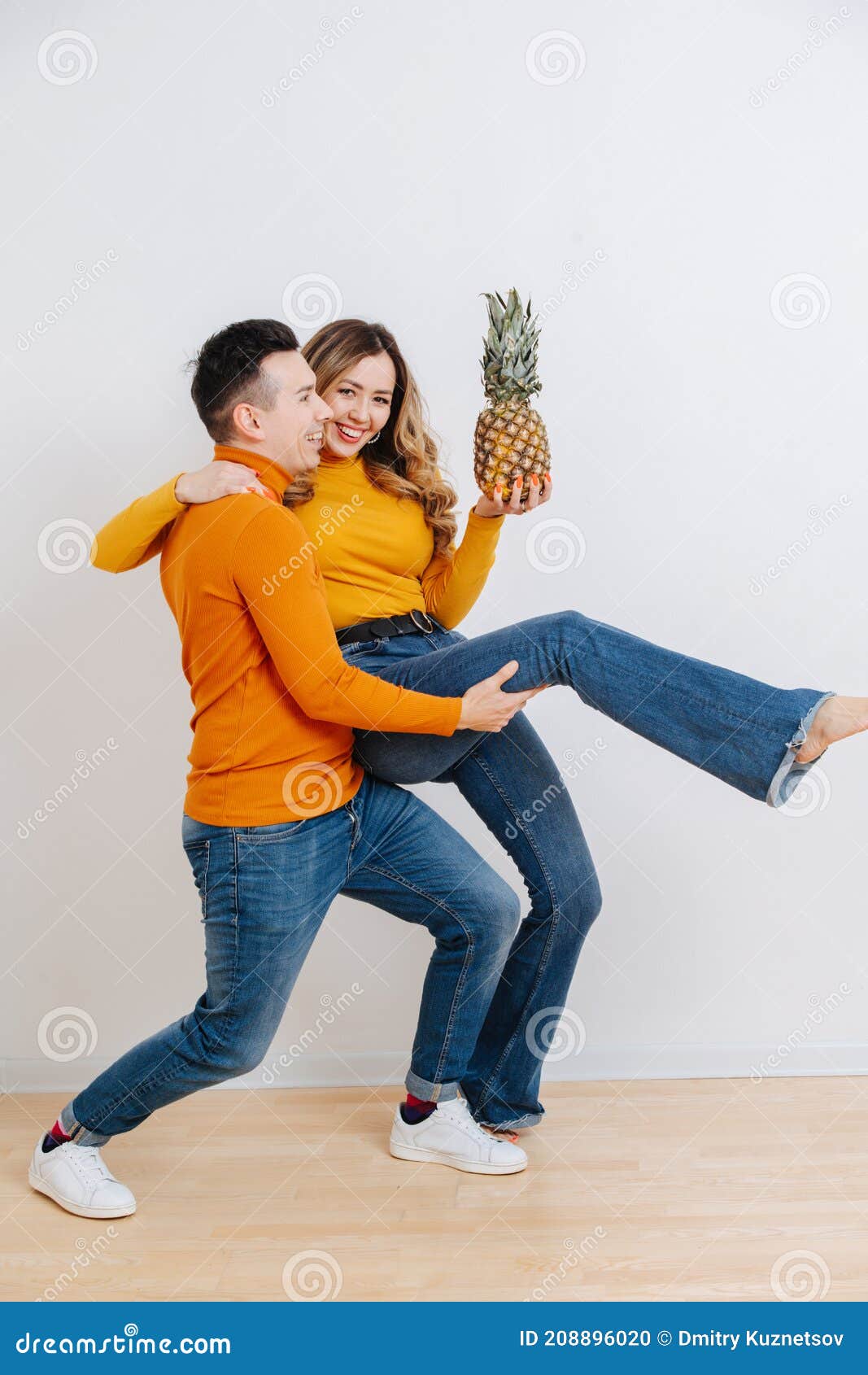 Funny Couple Fool Around And Dance Holding A Pineapple In Her Hand