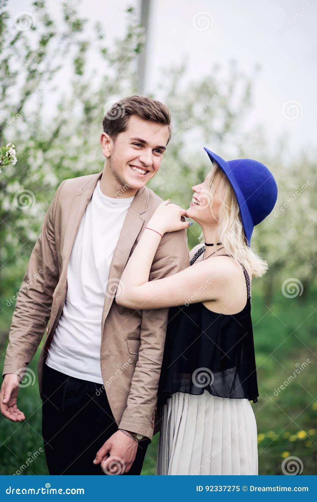 Funny Couple Laughing With A White Perfect Smile And Looking Each Other Outdoors Stock Image