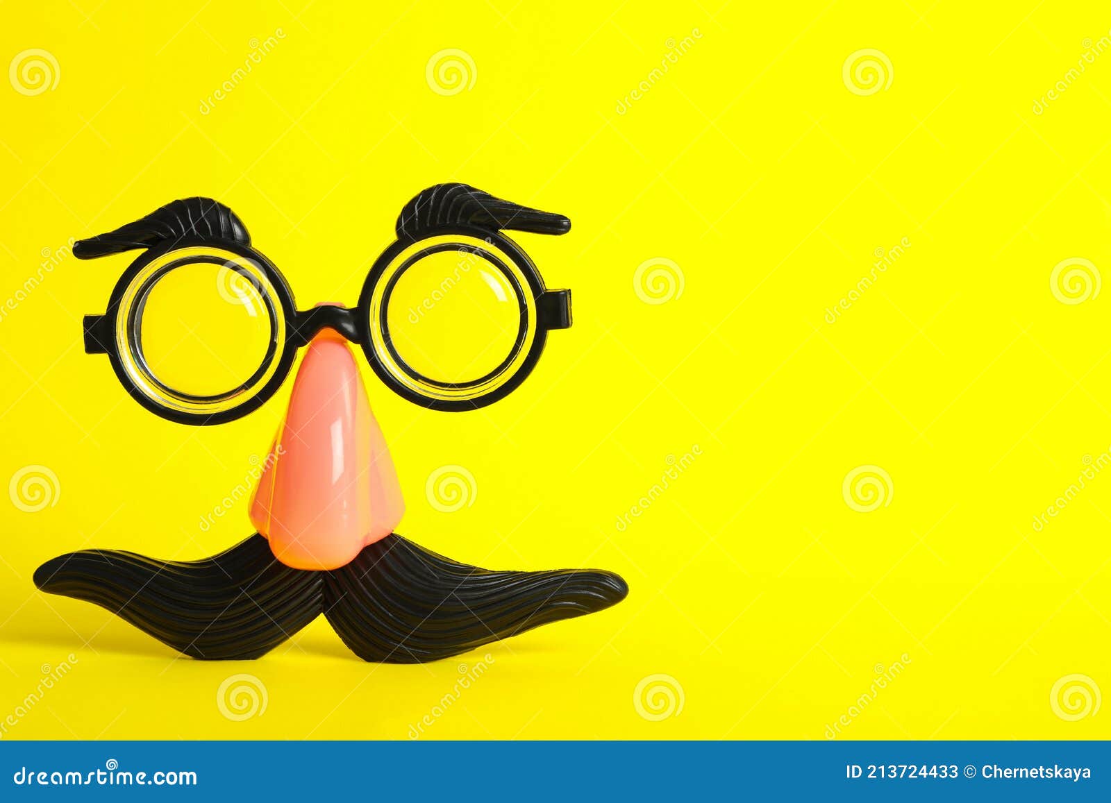 funny face made with clown`s accessories on yellow background, space for text