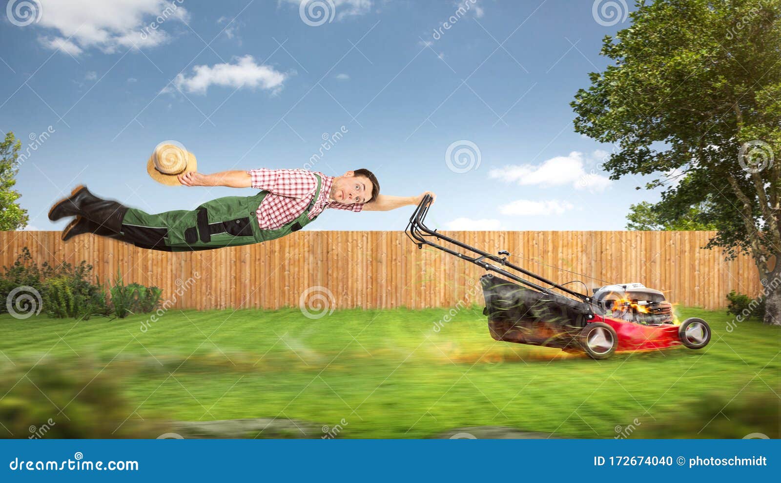 funny gardener being pulled through the garden by a lawn mower