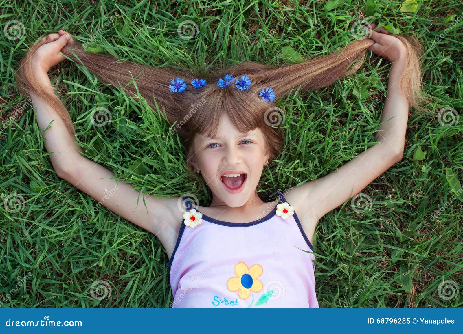 Funny Girl Lying on the Grass and Pulling Her Hair with Cornflowers Stock  Image - Image of cheerful, hair: 68796285