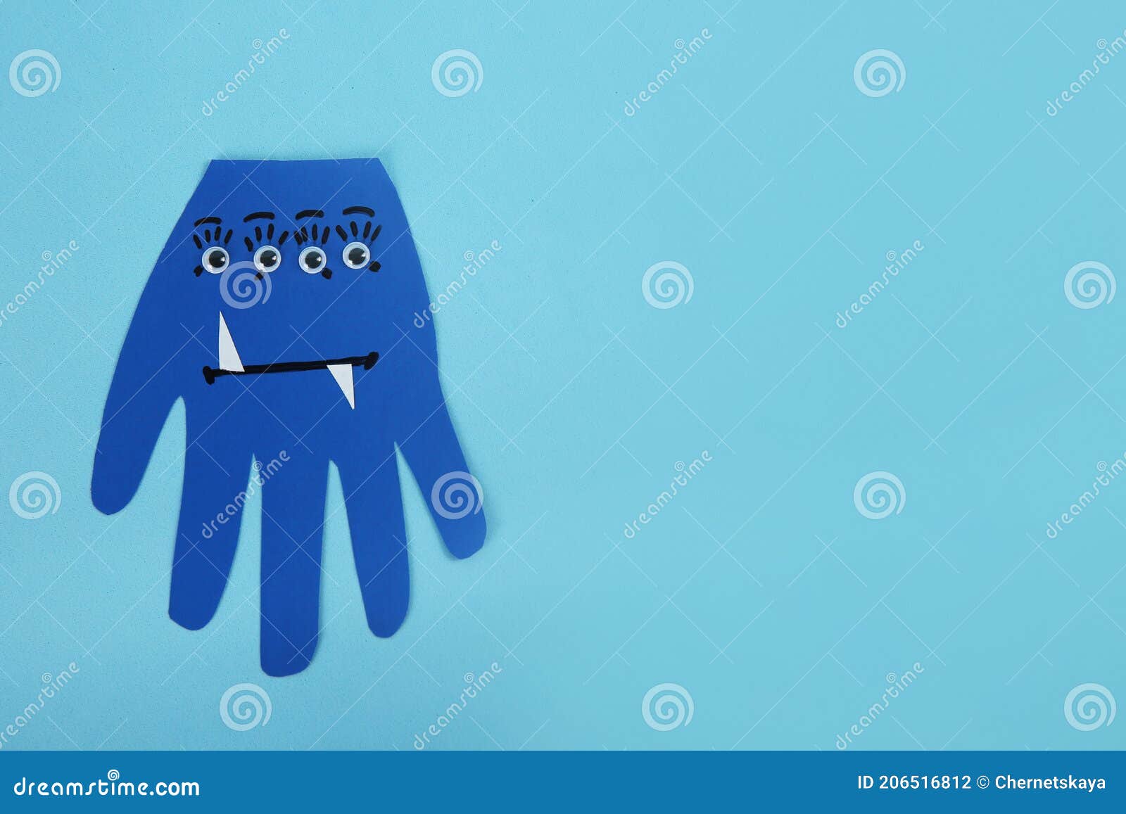Funny Hand Shaped Monster on Light Blue Background, Top View with