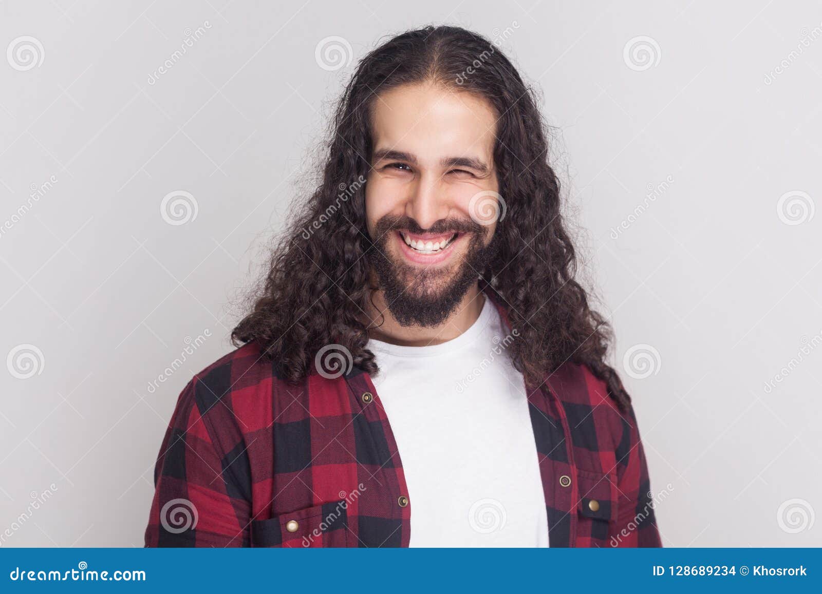 Funny Handsome Man with Beard and Black Long Curly Hair in Casual Style, Checkered Red Shirt Standing, Winking and Looking at Cam Stock Photo - Image of blink, funny: 128689234 Funny Handsome Man with Beard and Black Long Curly Hair in Casual Style, Checkered Red Shirt Standing, Winking and Looking at Cam Stock Photo - Image of blink, funny: 128689234