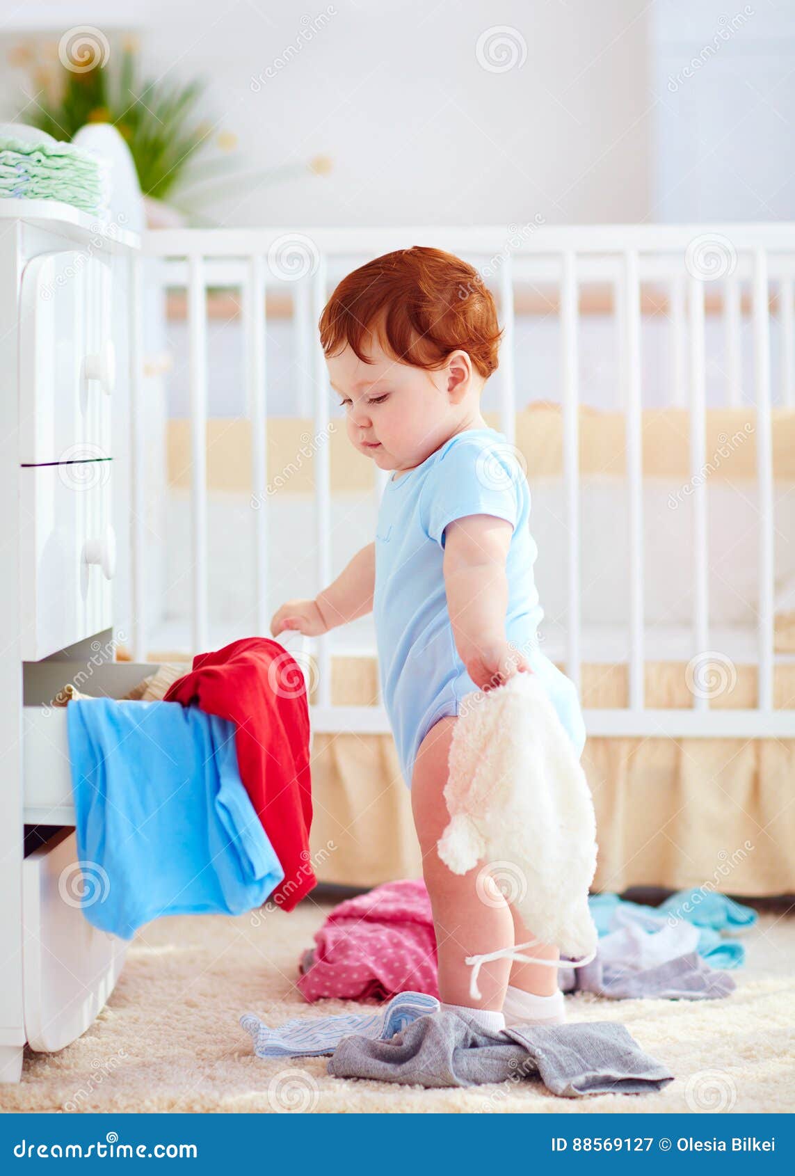 Funny Infant Baby Throwing Out Clothes From The Dresser At Home