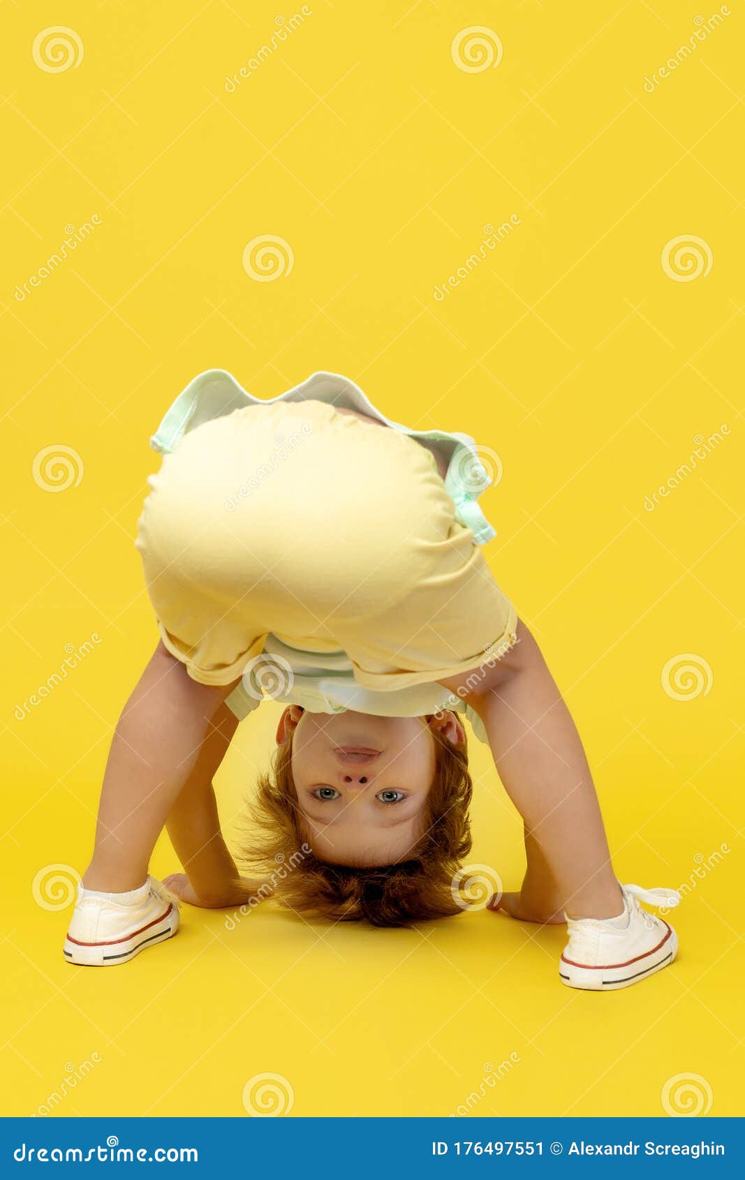 Funny Kid Playing Upside Down Over Yellow Background. Stock Image - Image  of play, fashionable: 176497551