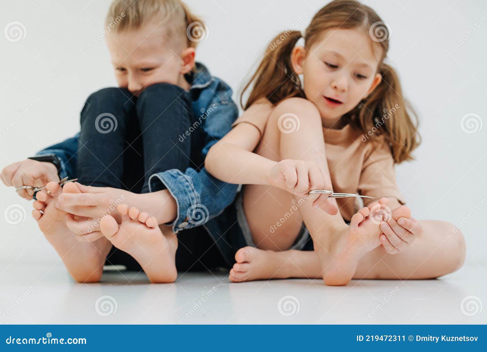 Funny Kids. Little Siblings with Bare Feet Clipping Nails on Their ...