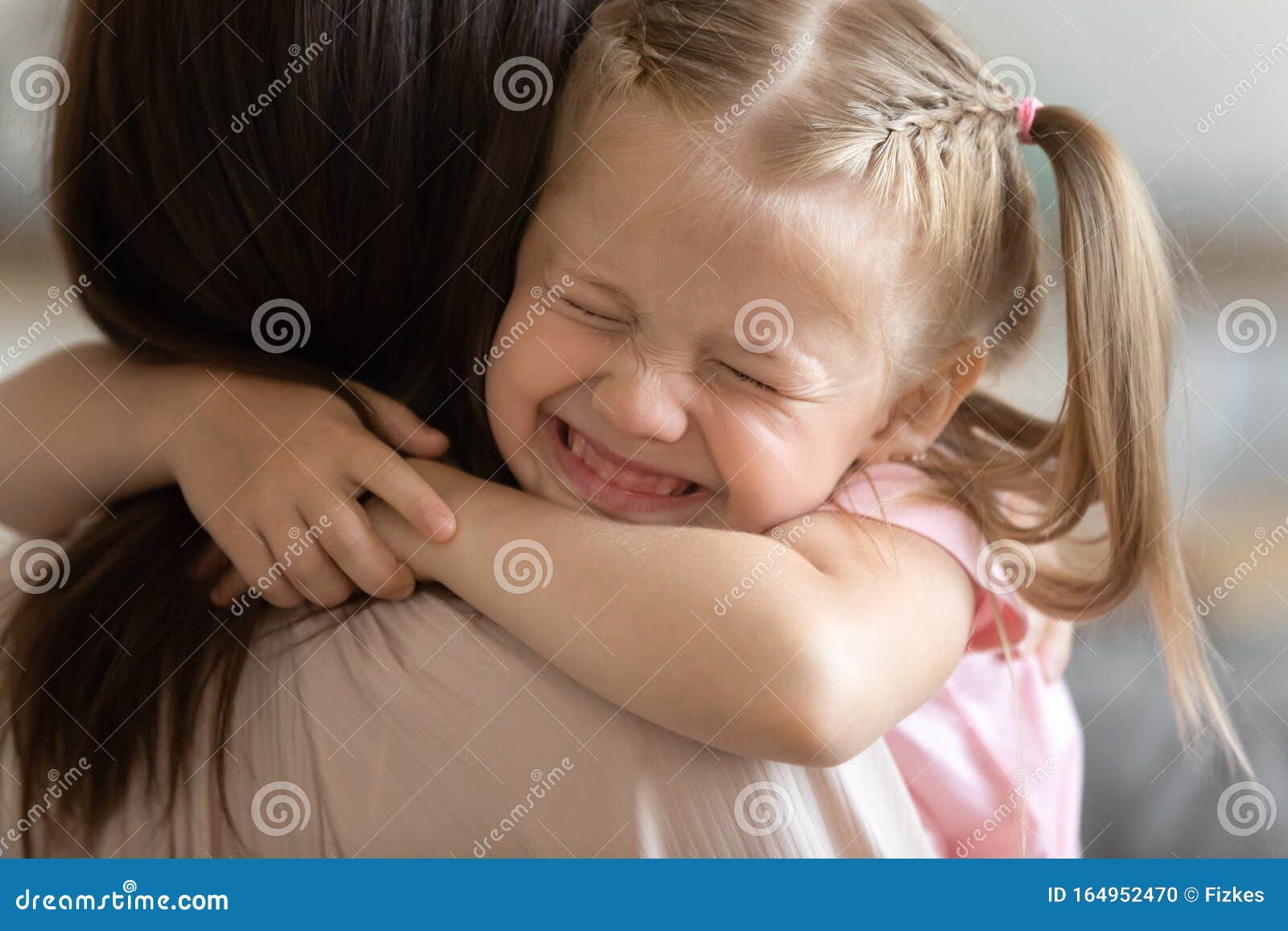 funny cute little girl smiling embracing foster care parent mum