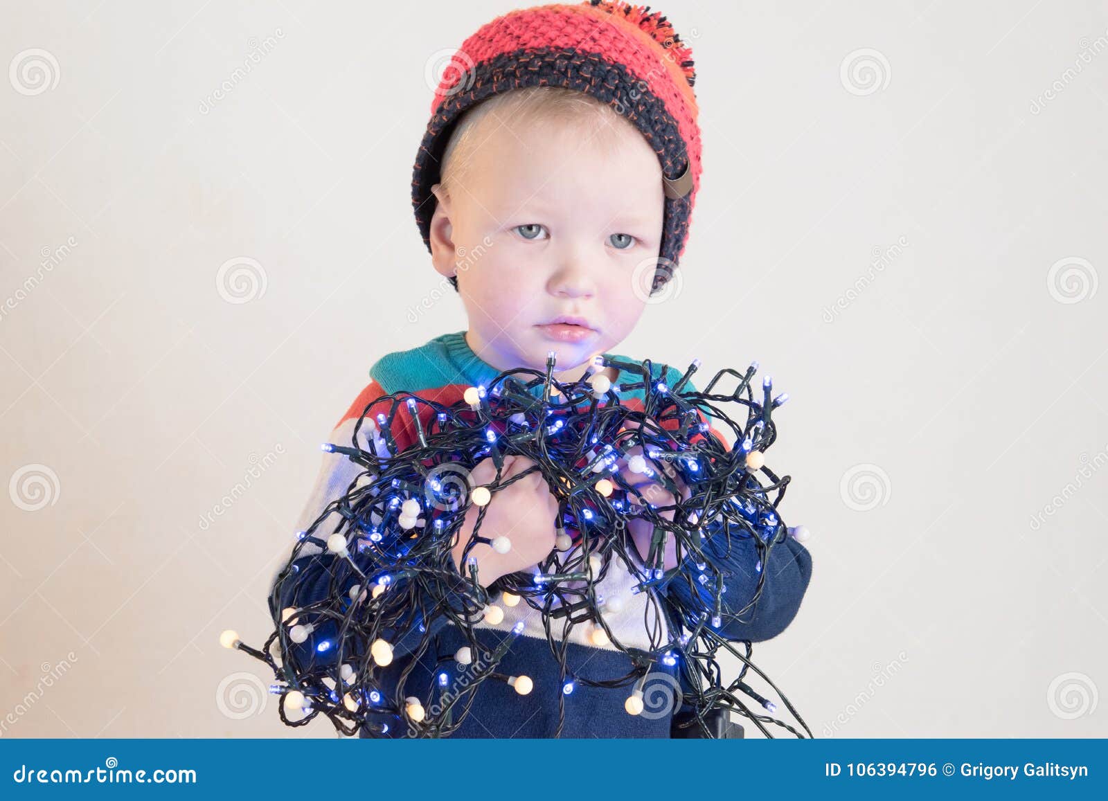 funny little smiling kids driving toy car with christmas tree. happy child in colour fashion clothes bringing hewed xmas tree from