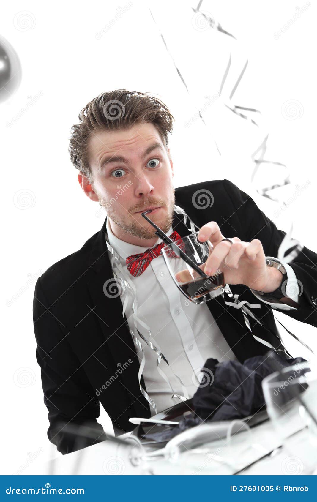 Funny looking party guy in a suit and bowtie. White background with balloons.