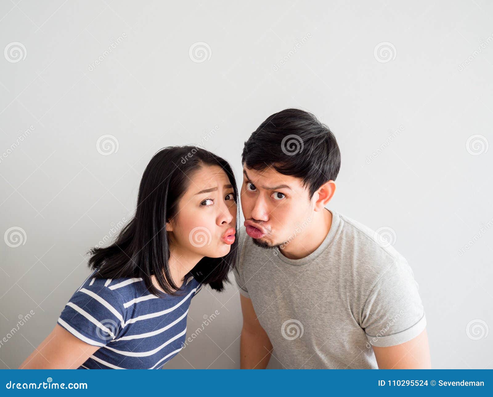 Funny Lovely Couple Trying To Kiss Each Other Concept Of Comedy