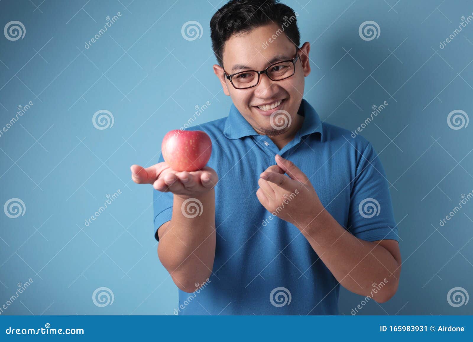 Funny Man Eating Red Apple stock image. Image of blue - 165983931