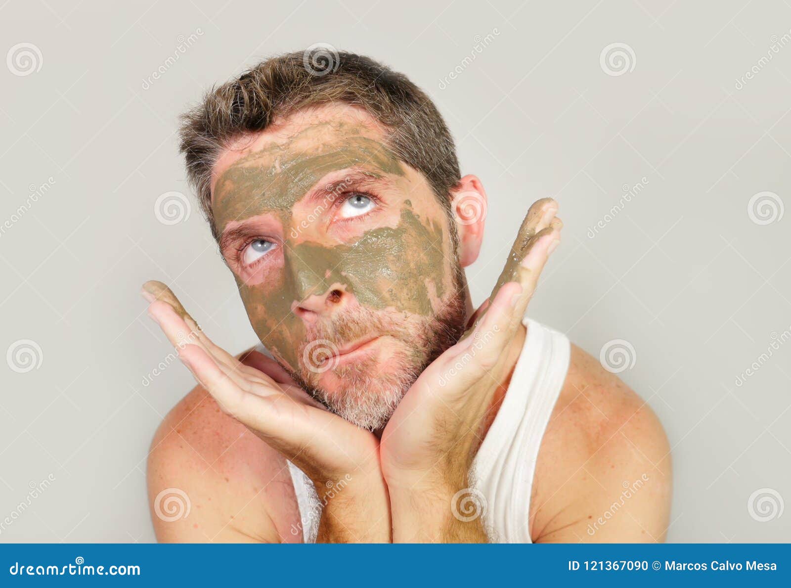 Funny Man With Green Seaweed Facial Mask On His Face Posing In Front Of The Mirror Mocking On Himself Using Skin Care Beauty Prod Stock Photo Image Of Model Person 121367090