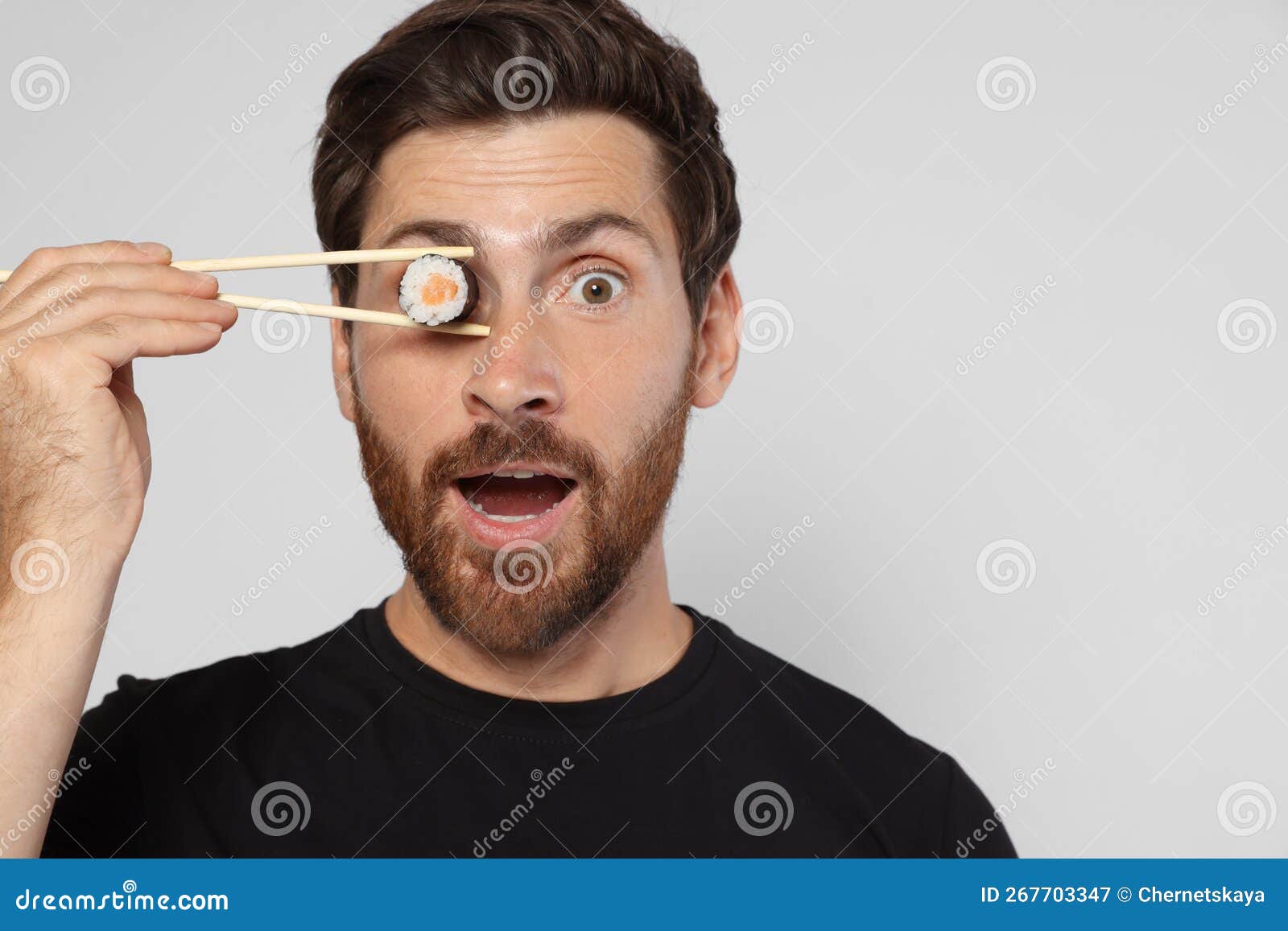 Funny Man Hiding His Eye with Sushi Roll on Light Grey Background