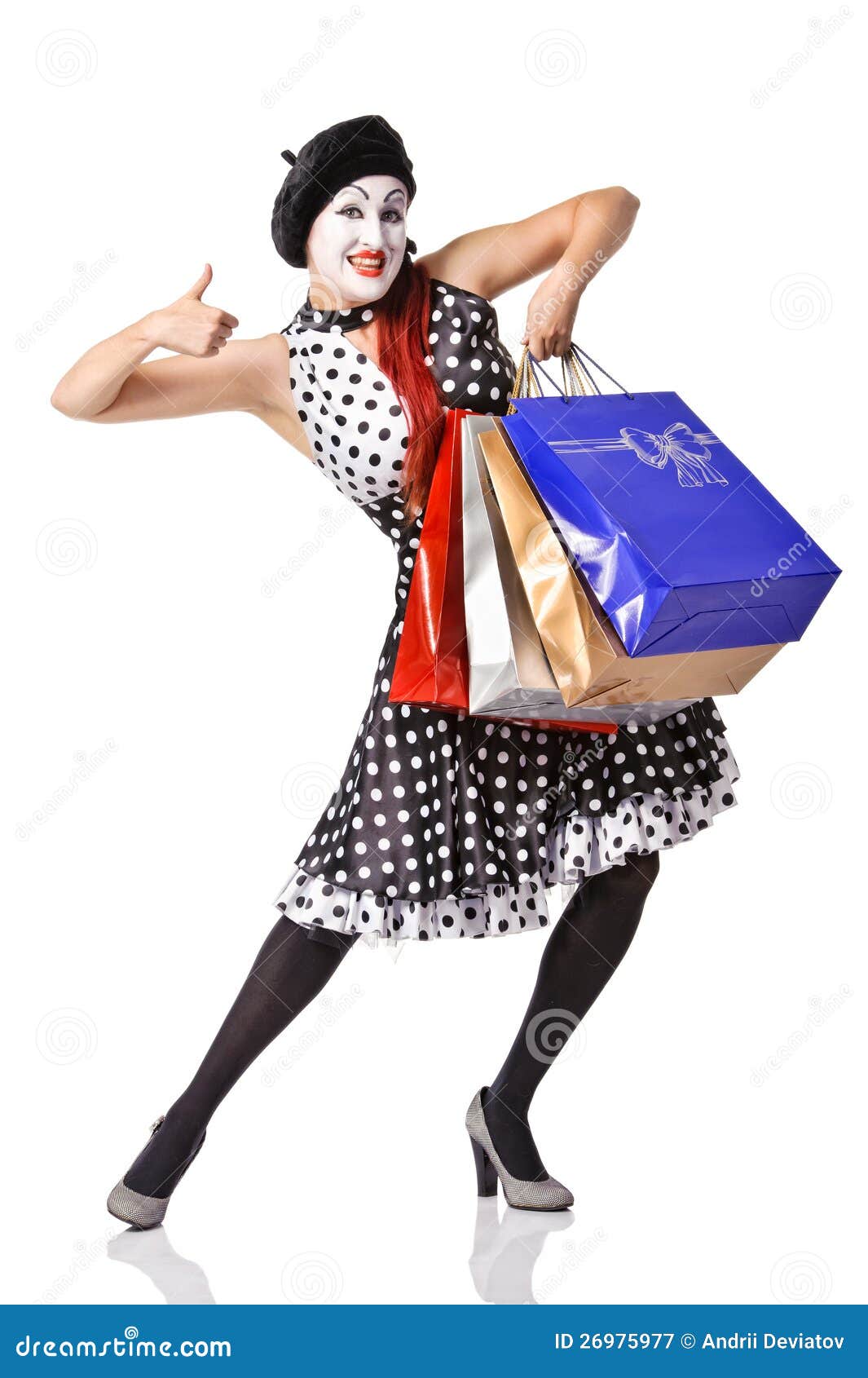 funny mime in spotty dress holding shopping bags