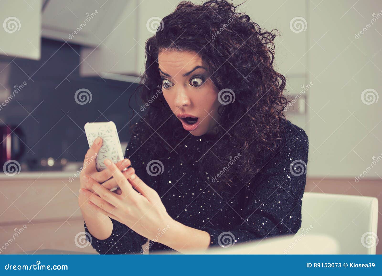 funny shocked anxious woman looking at phone seeing bad photos message