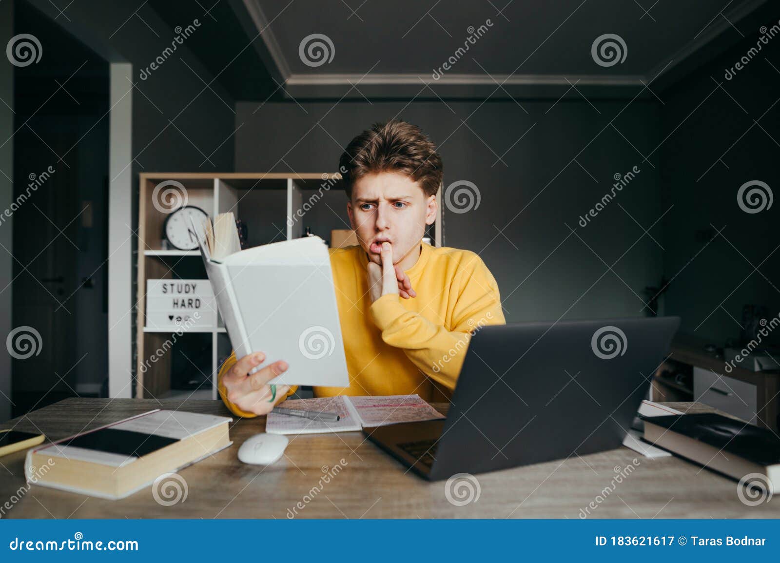 Funny Student Studying at Home in the Bedroom, Sitting at a Table ...