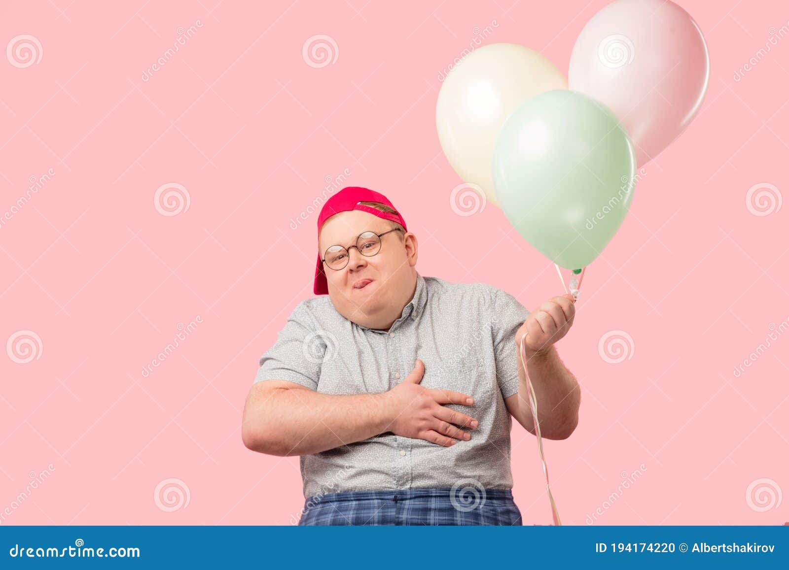 funny tubby guy with positive emotions smiling happily, holding air balloons.