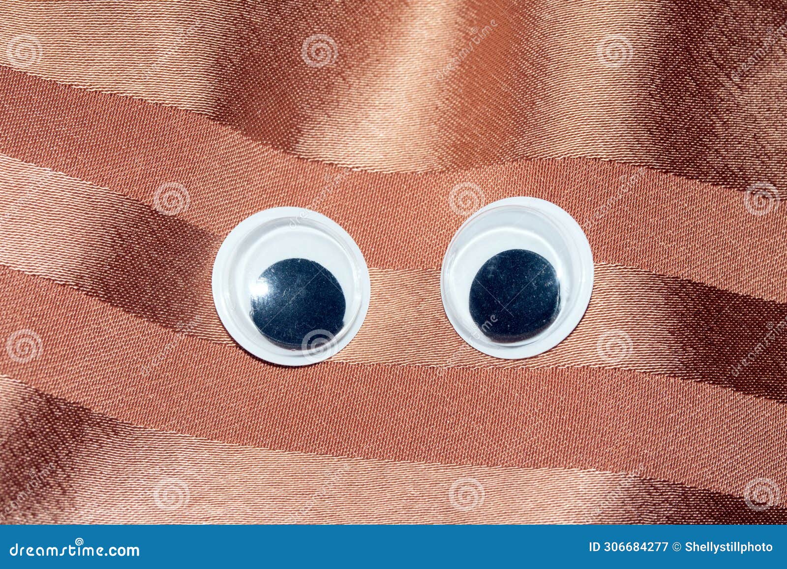 funny wiggle google eyes on fabric background