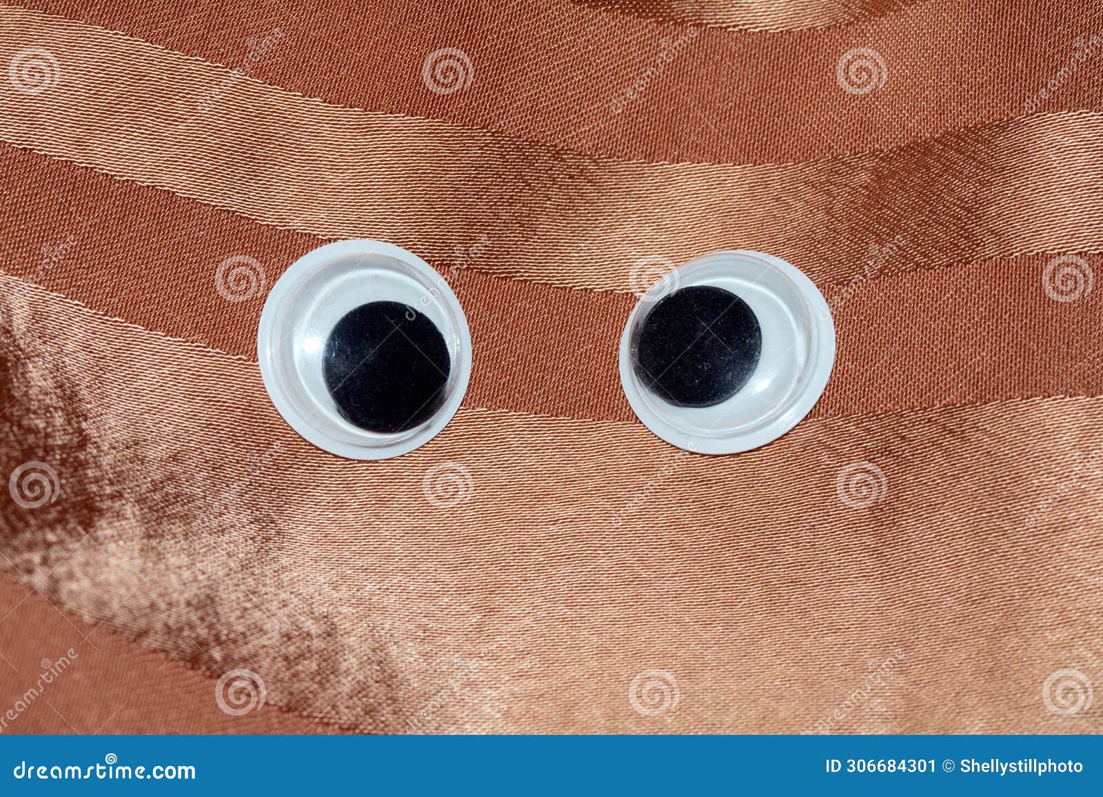 funny wiggle google eyes on fabric background