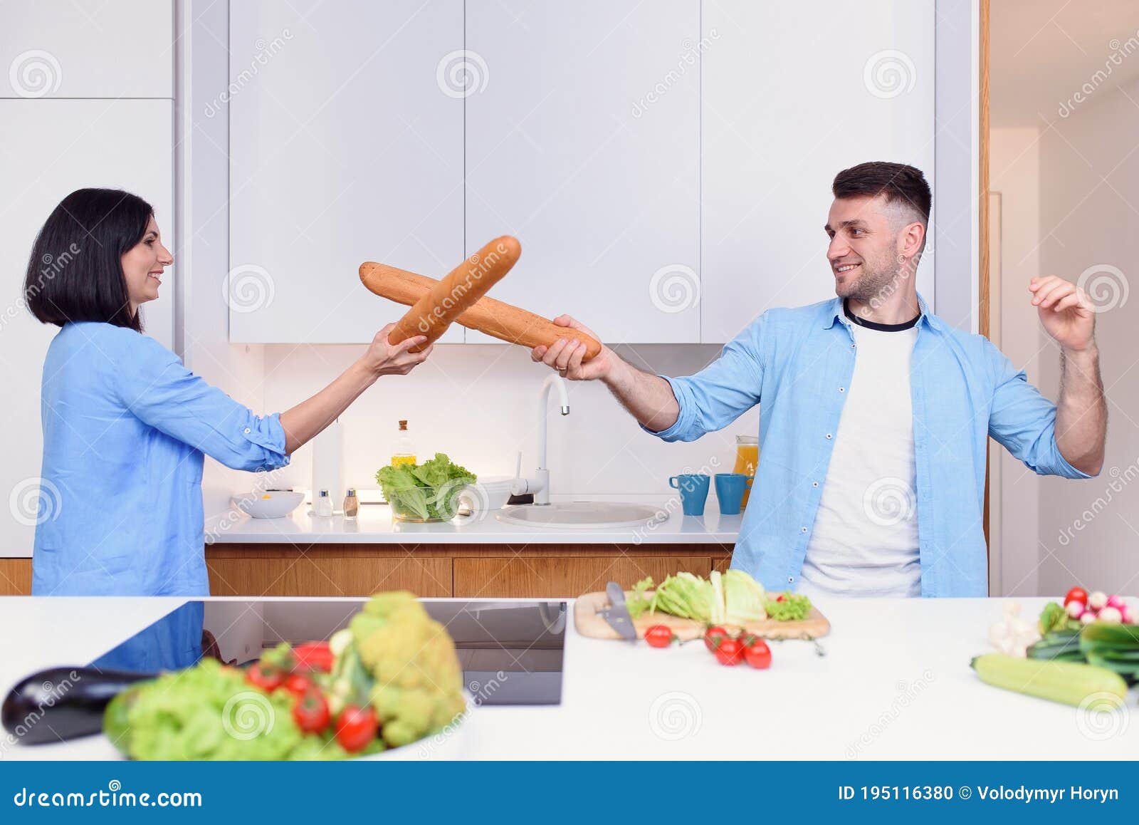 Funny Couple Fight with Baguettes while Cooking at Home Together, Husband  and Wife Feeling Playful in the Kitchen. Stock Photo - Image of girl,  husband: 195116380