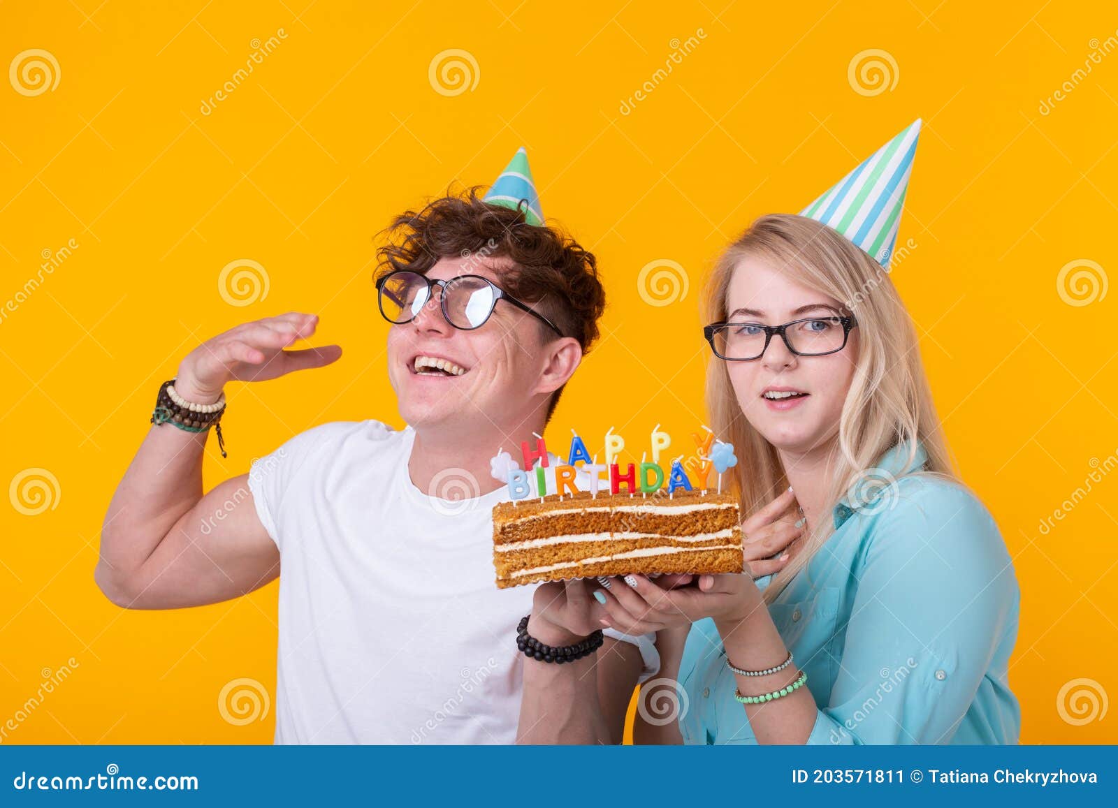 Funny Young Couple in Paper Caps and with a Cake Make a Foolish ...