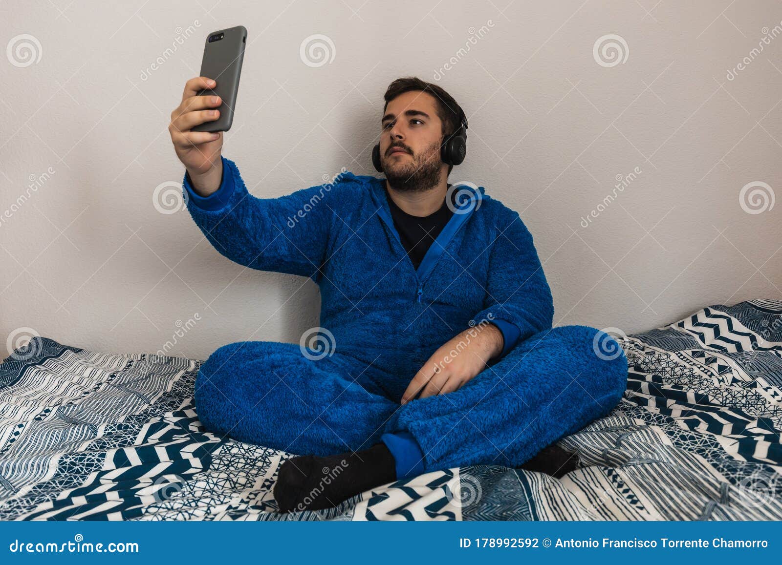 Funny Young Guy in a Fantastic Pyjama in His Bedroom. he is Taking a Selfie  Stock Photo - Image of person, technology: 178992592