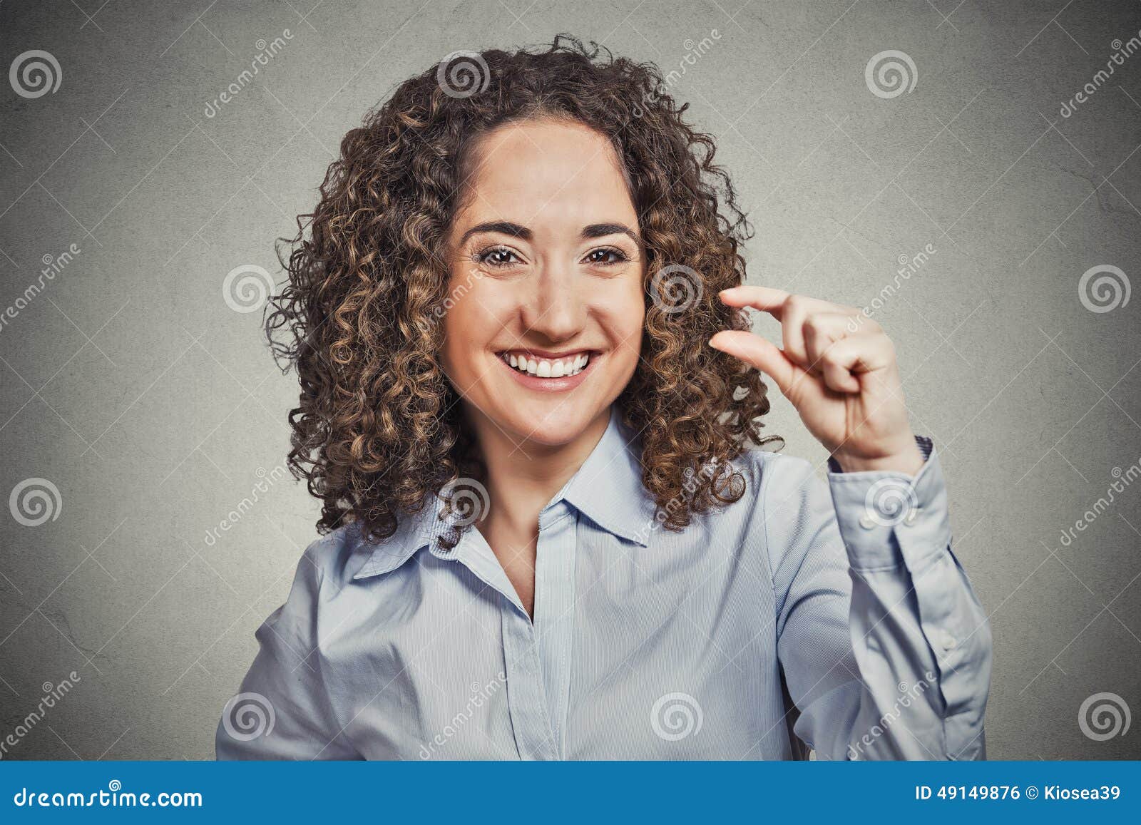 funny-young-woman-showing-small-amount-size-gesture-hand-closeup-portrait-curly-brown-hair-fingers-isolated-grey-background-49149876.jpg