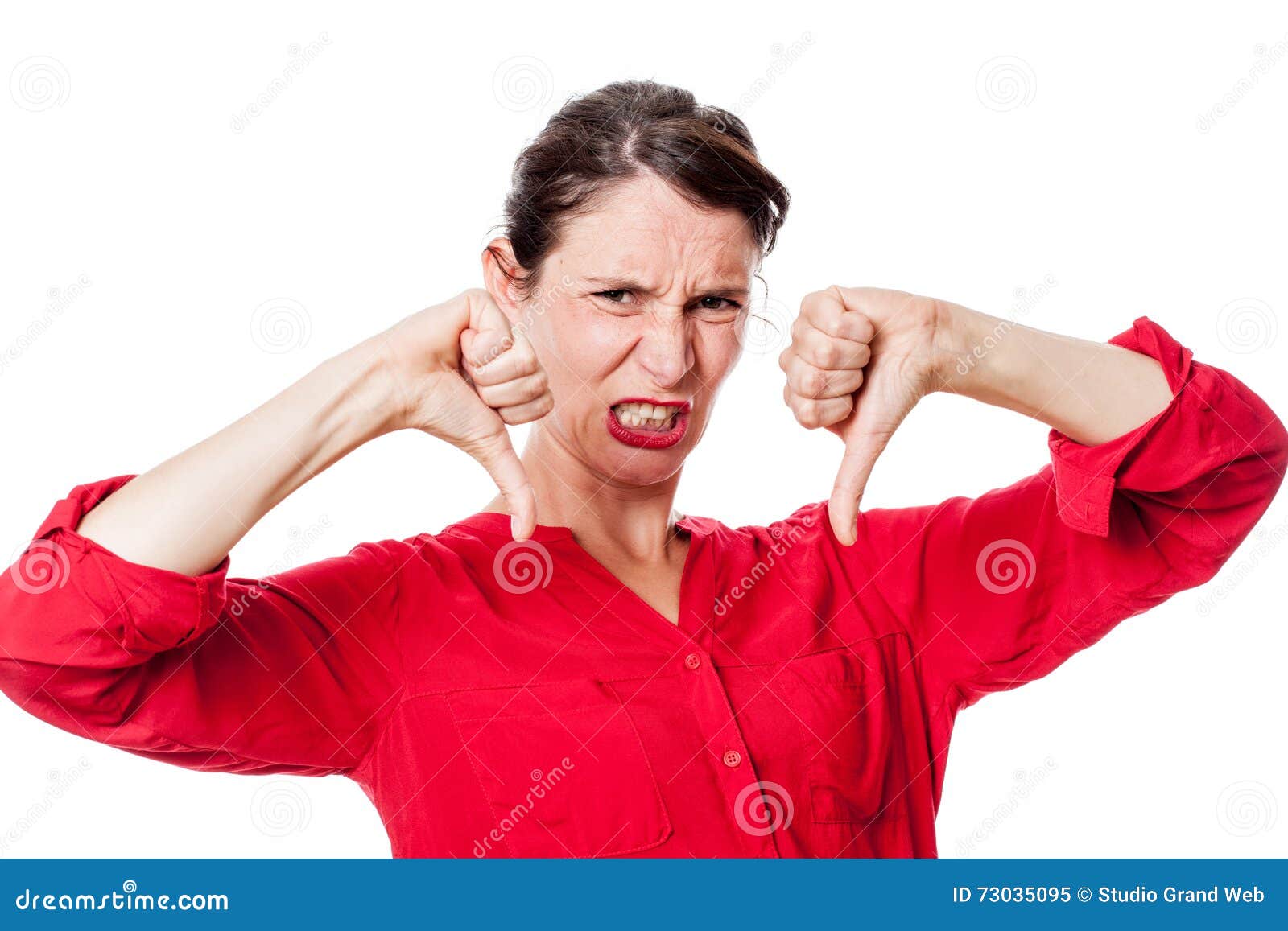 furious young woman with disappointed thumbs down grinding teeth