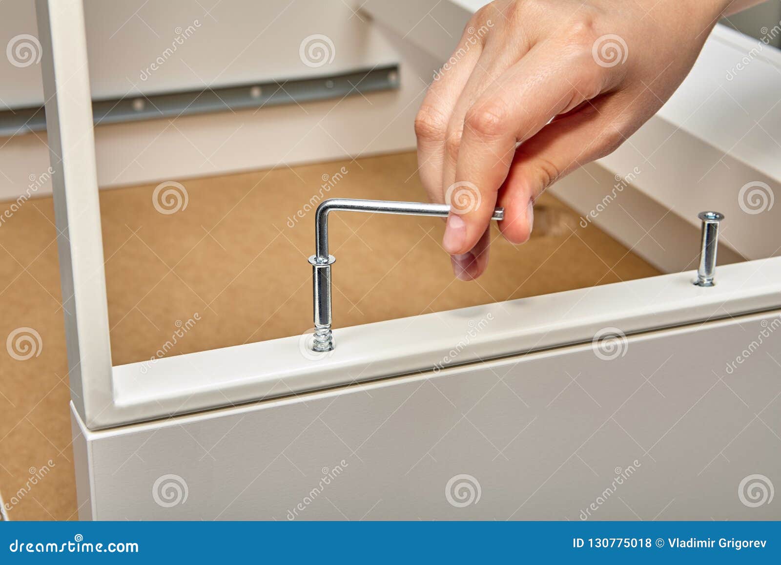 Furniture Assembler Tightens Furniture Connector Into Table With