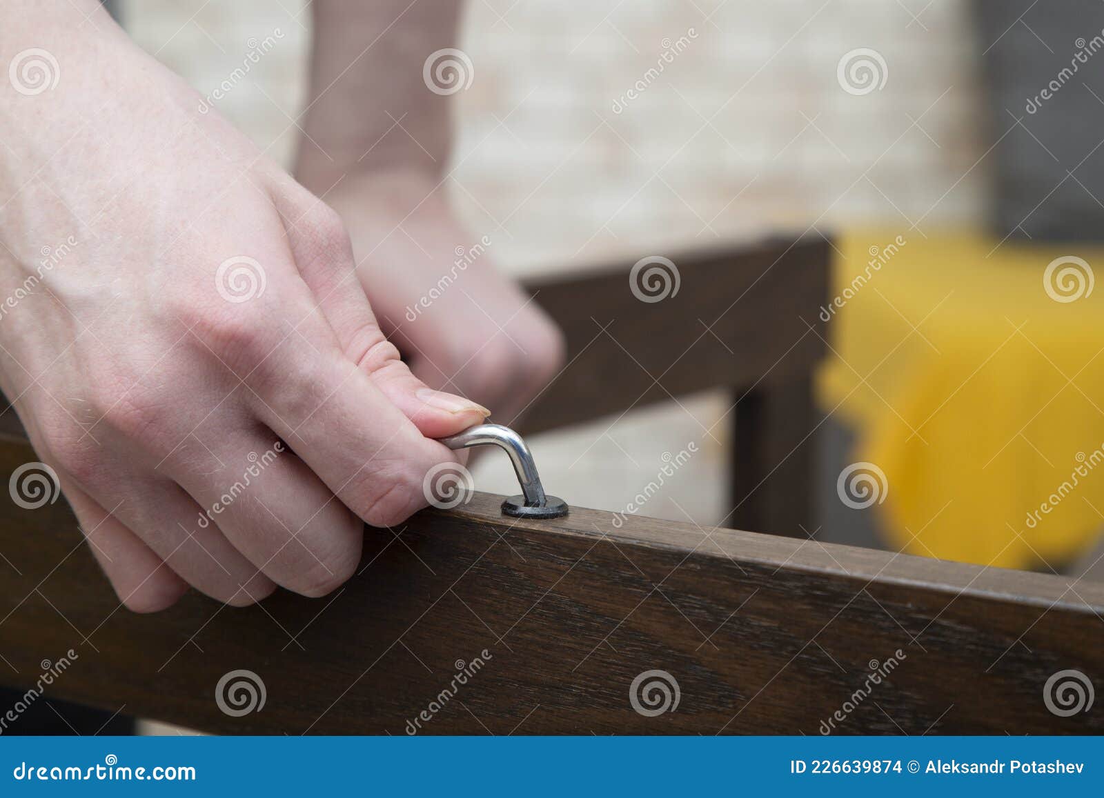 Furniture Assembly.an Employee Collects Furniture Using a Special Tool