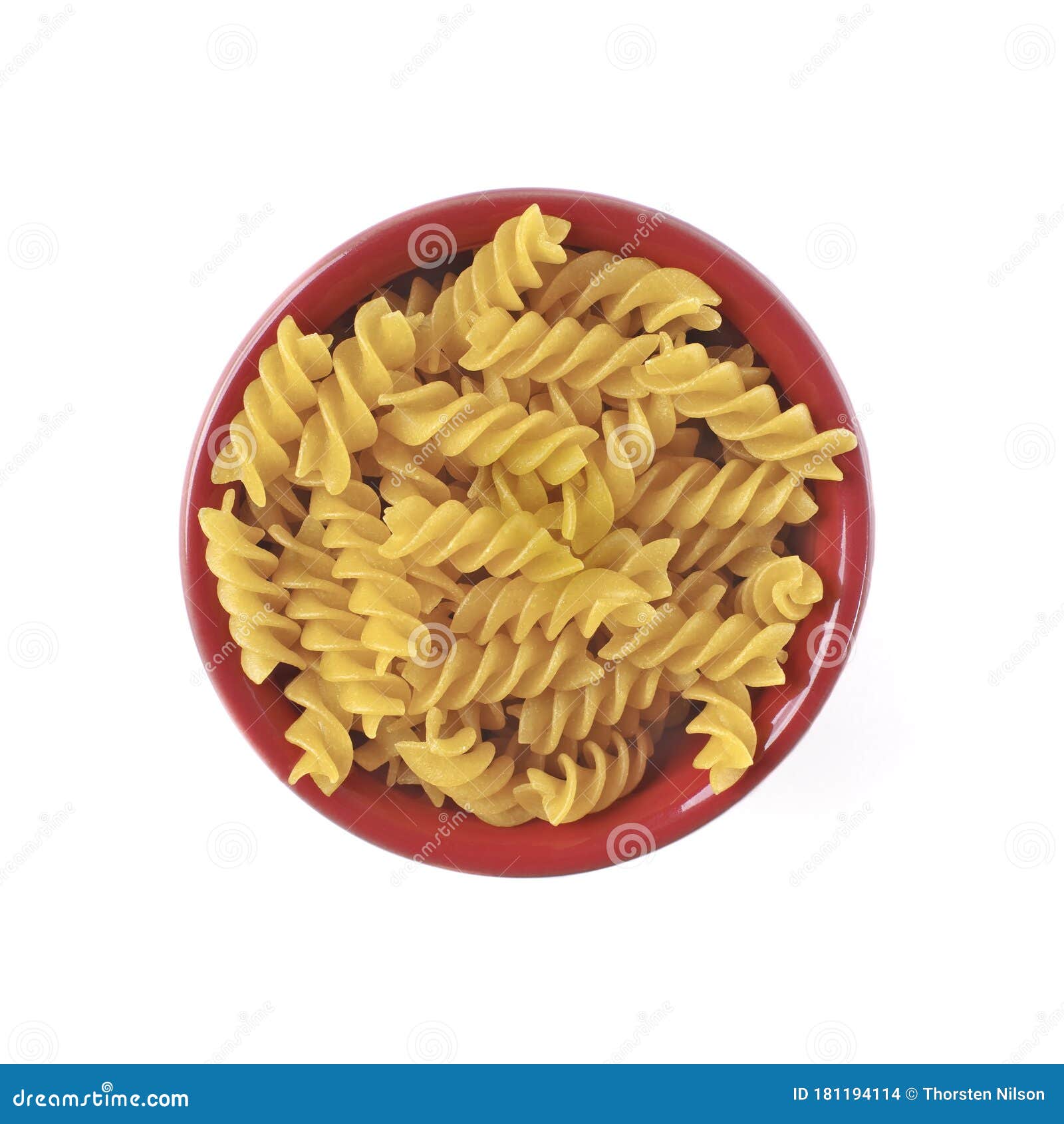 Fusilli Noodles in a Red Bowl Isolated on White Background. Stock Photo