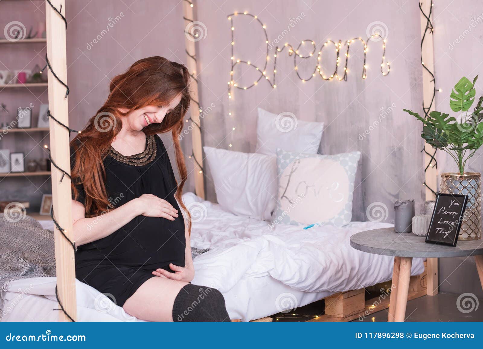 Red-haired Young Pregnant Woman Sitting At Home On The 