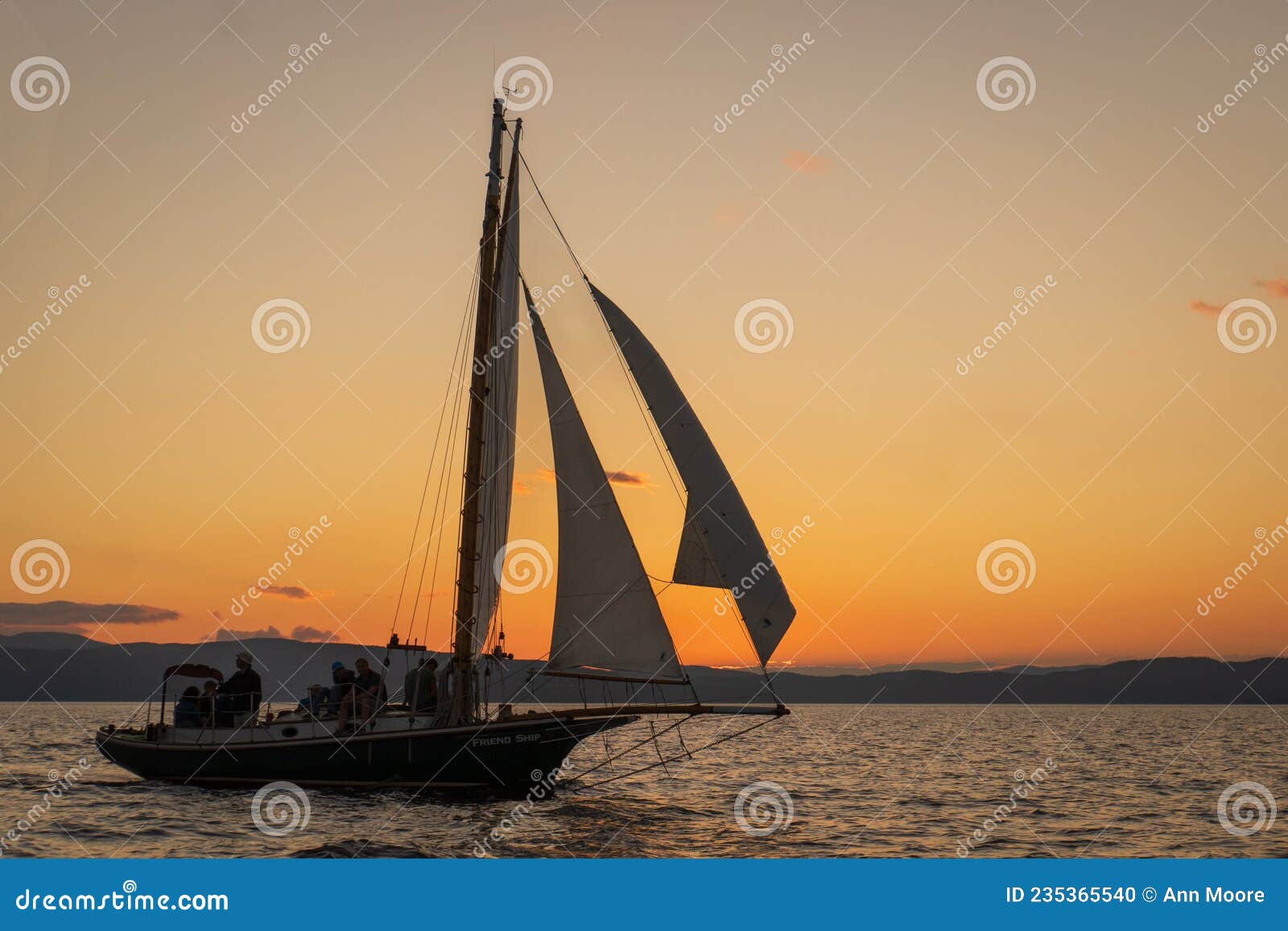gaff-rigged sloop at sunset