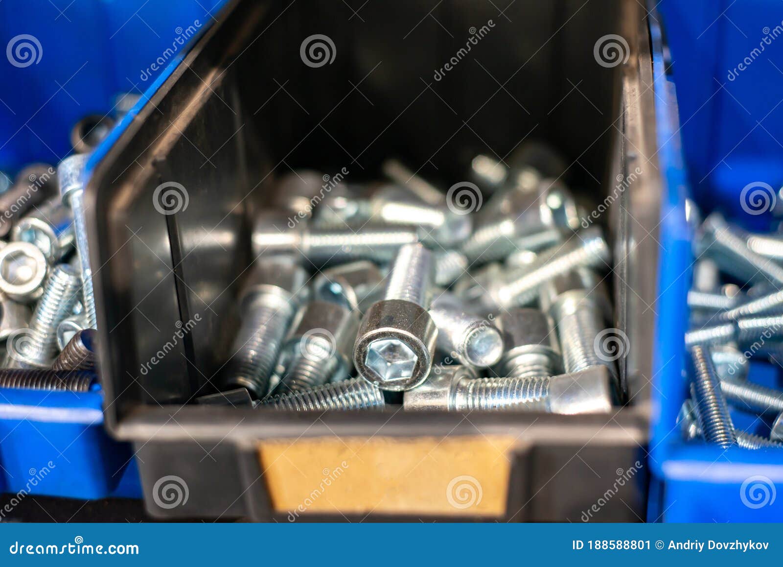 Galvanized Steel Bolts, Screws, Nuts in a Blue Plastic Box on a Rack in