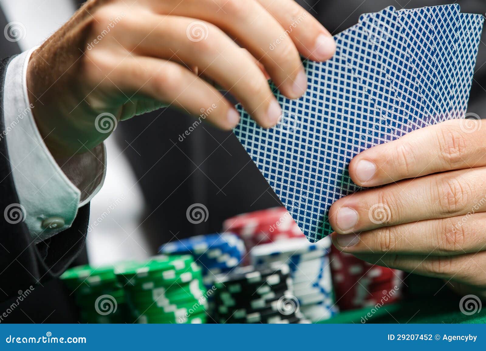 Gambler playing poker cards with poker chips on the poker table. Risky entertainment of gambling