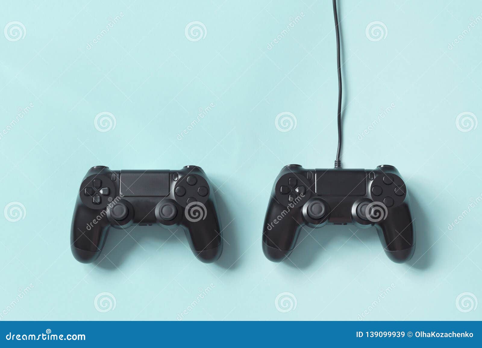 gamepad connected wire from the game console on blue background. concept of game tournaments