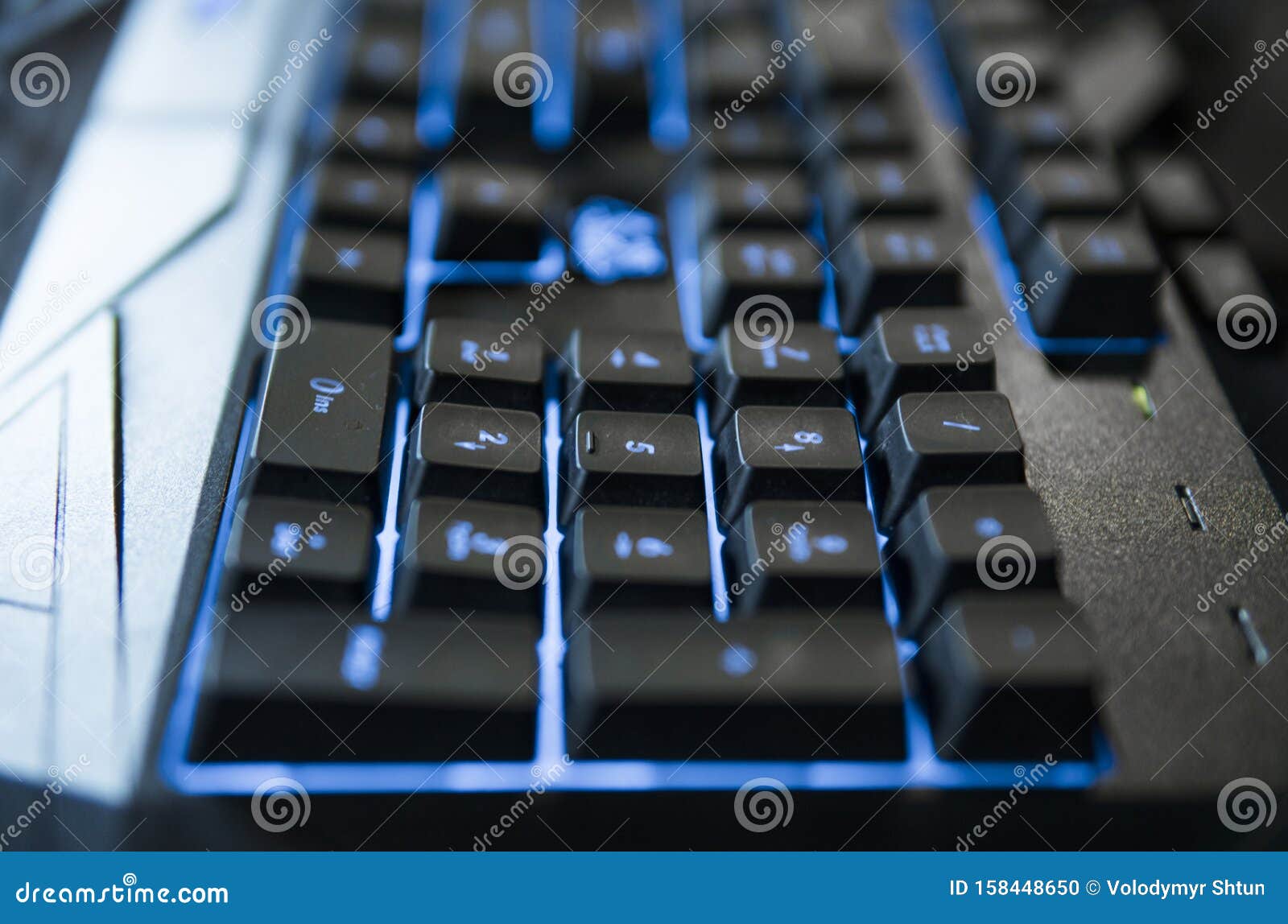 gamer keyboard with colorful blue lights, modern gamer computer. blue backlight, backlit on laptop or keyborad computer