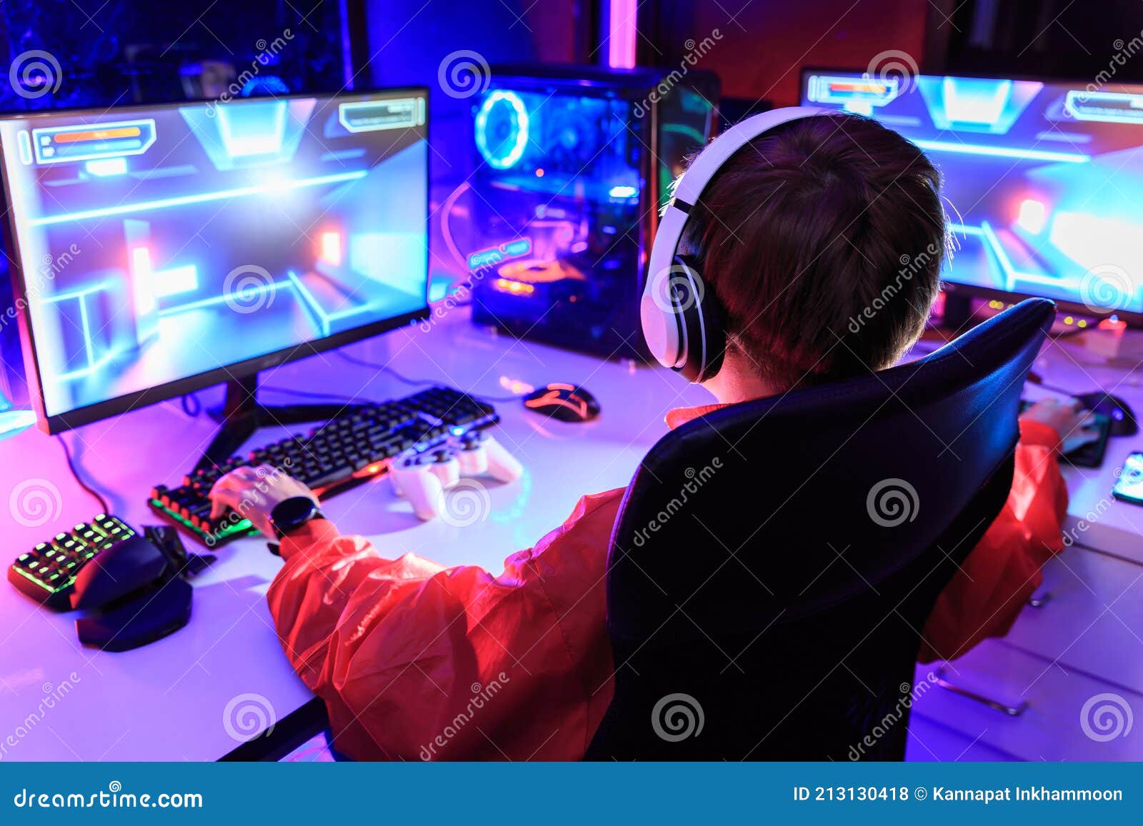 Young gamer play online with friends. Dark scene with gaming PC and lots of  RGB light Stock Photo - Alamy