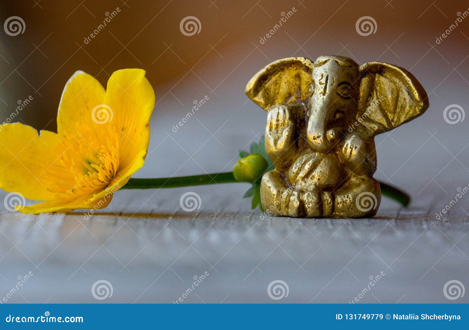 Ganesha Figure with Bright Yellow Flower Closeup. Beautiful Ganesh ...