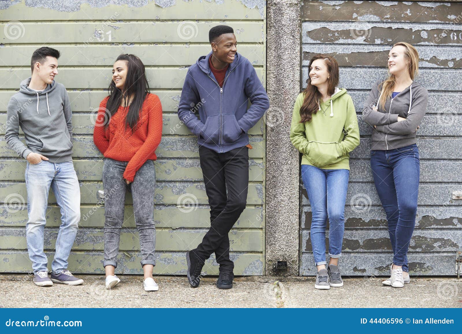 gang of teenagers hanging out in urban environment