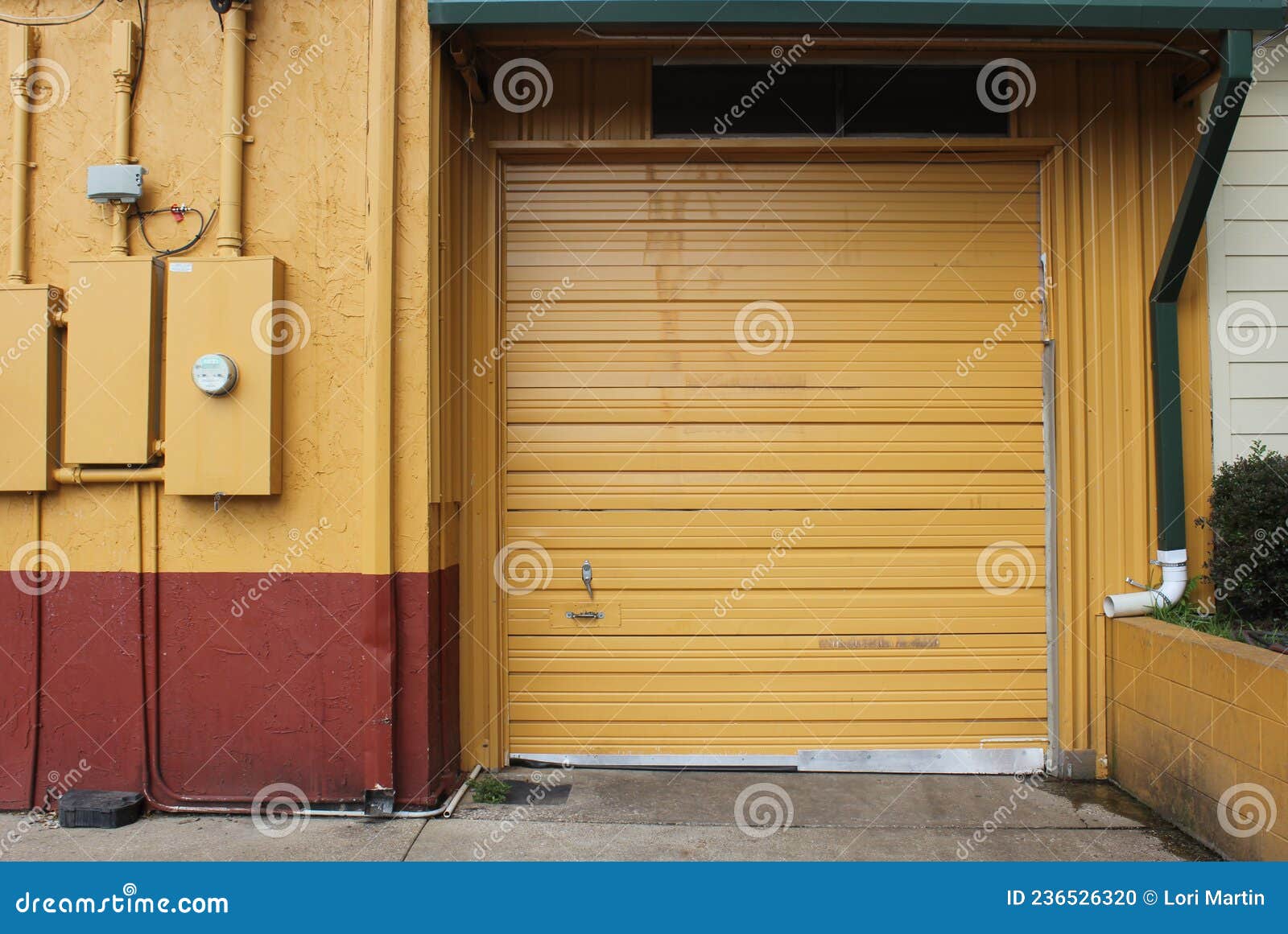Garage Door on Warehouse and Regular Door Stock Photo Image of