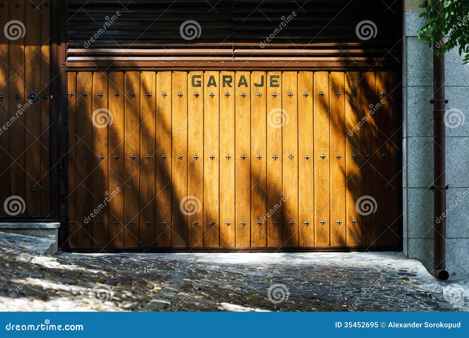garage gates with shadows of trees