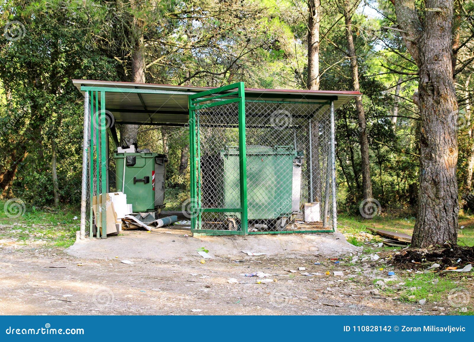 garbage containers in fence cage / orderly stowed garbage cans for separate garbage collection.