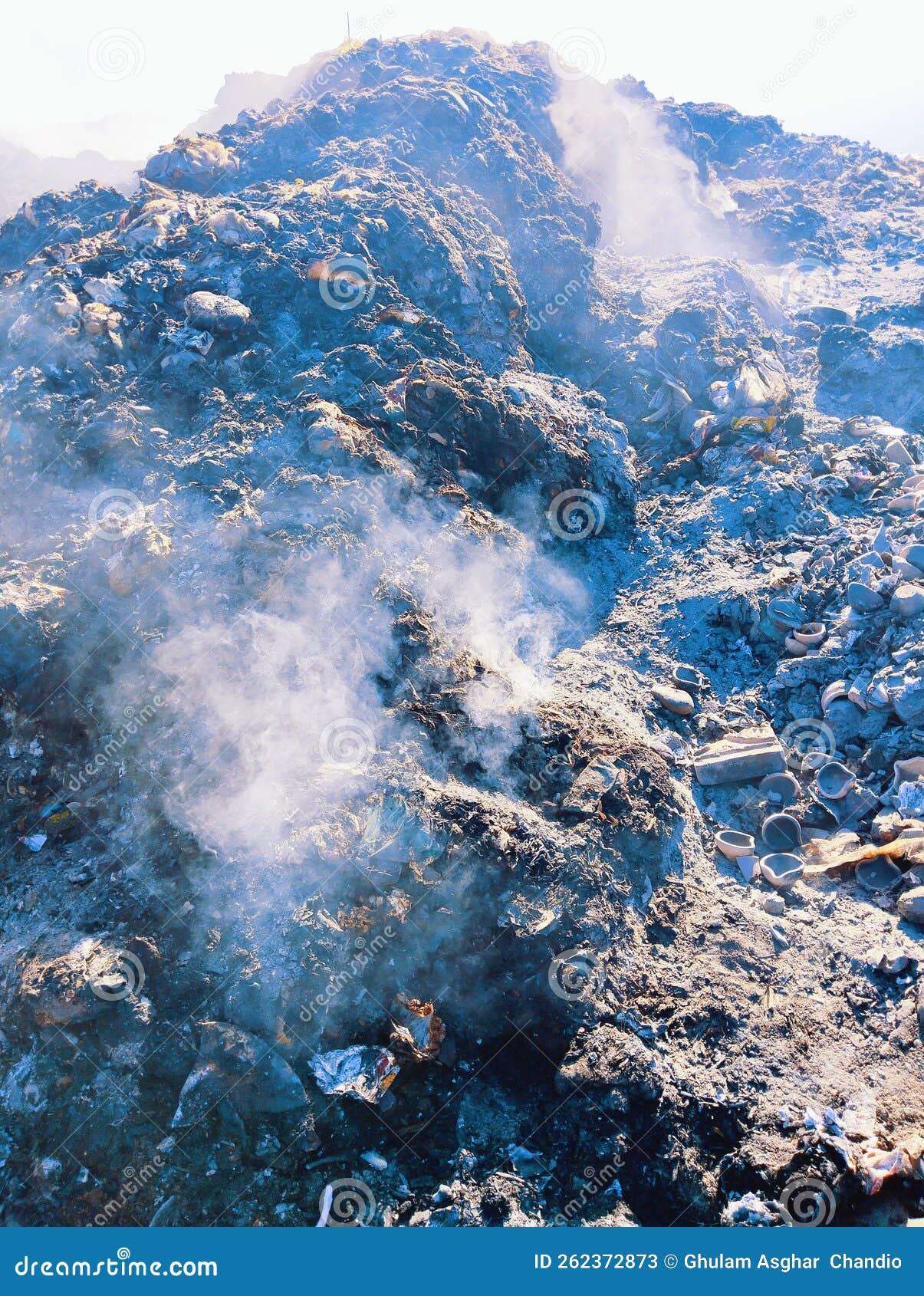 garbage heap burnt waste pile on fire trash smoke rubbish burning ashes air pollution dump litter  image photo
