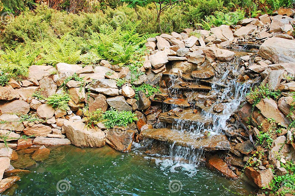 Garden pond and waterfall stock photo. Image of rocks 15387426