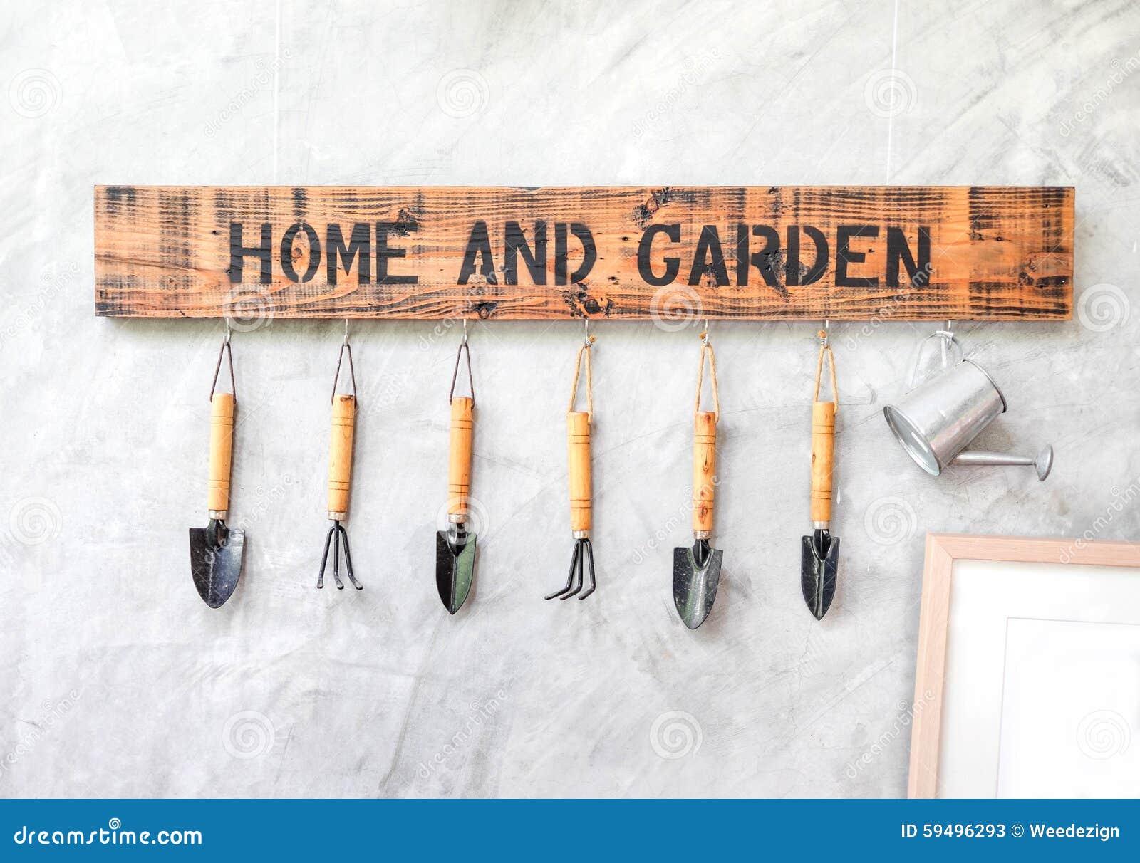 Garden Tool Hanging on Concrete Wall with Wooden Label Stock Image