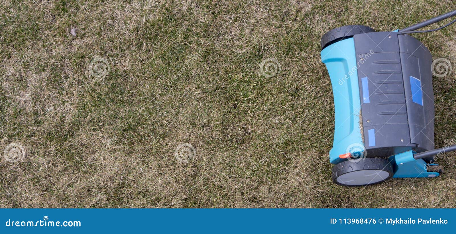 Gardener Operating Soil Aeration Machine on Grass Lawn Stock Photo