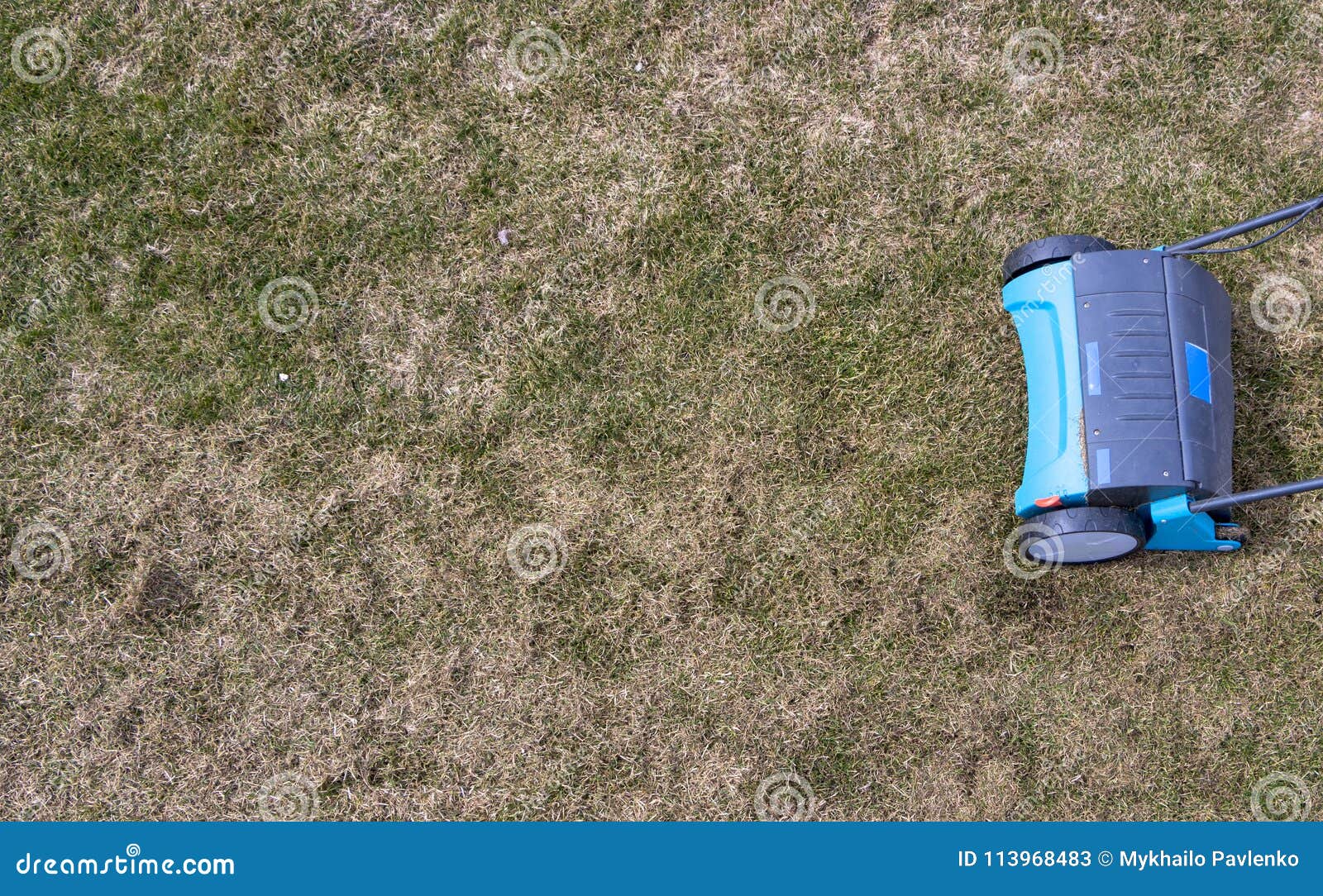 Gardener Operating Soil Aeration Machine on Grass Lawn Stock Image