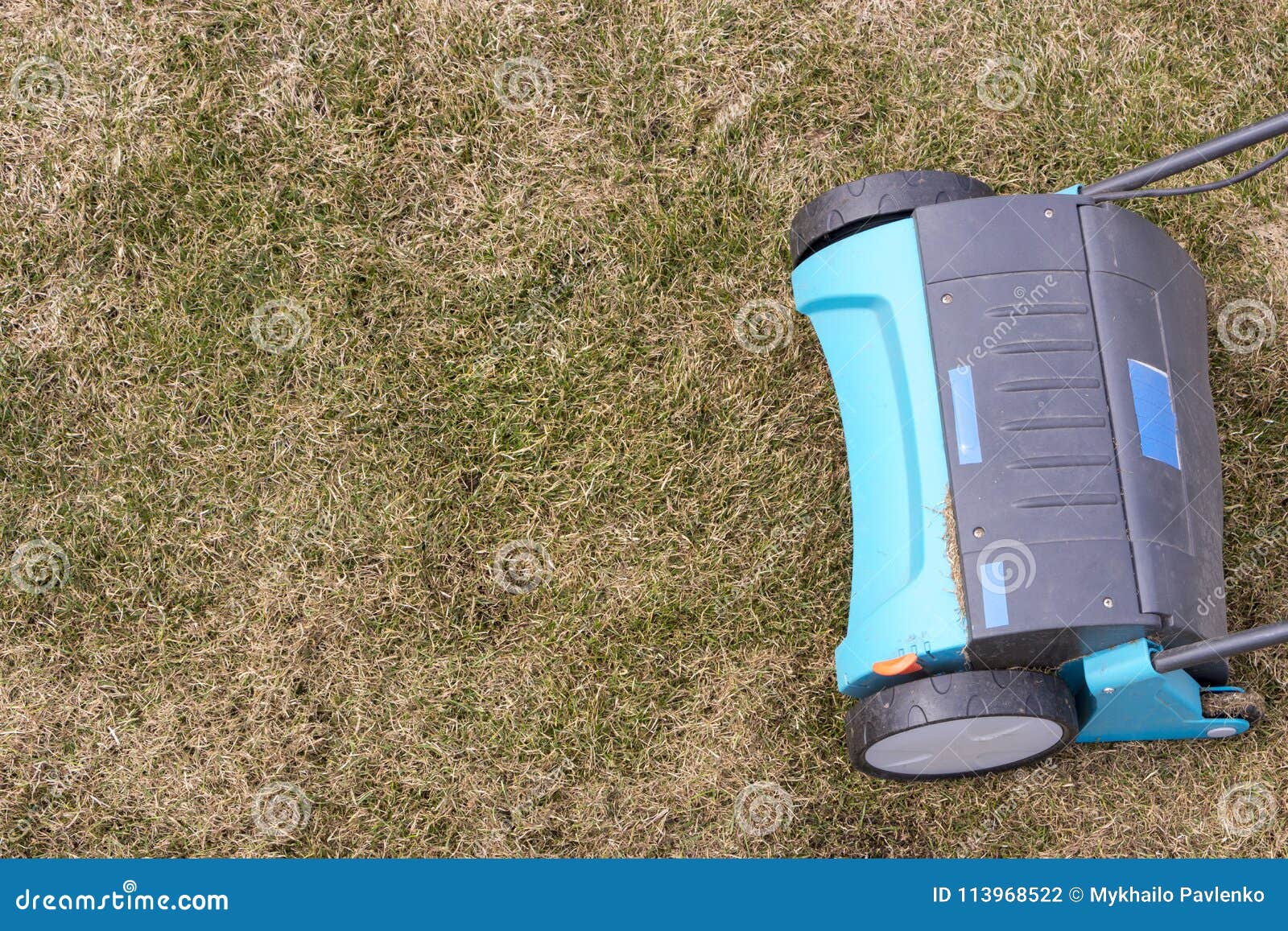 Gardener Operating Soil Aeration Machine on Grass Lawn Stock Photo