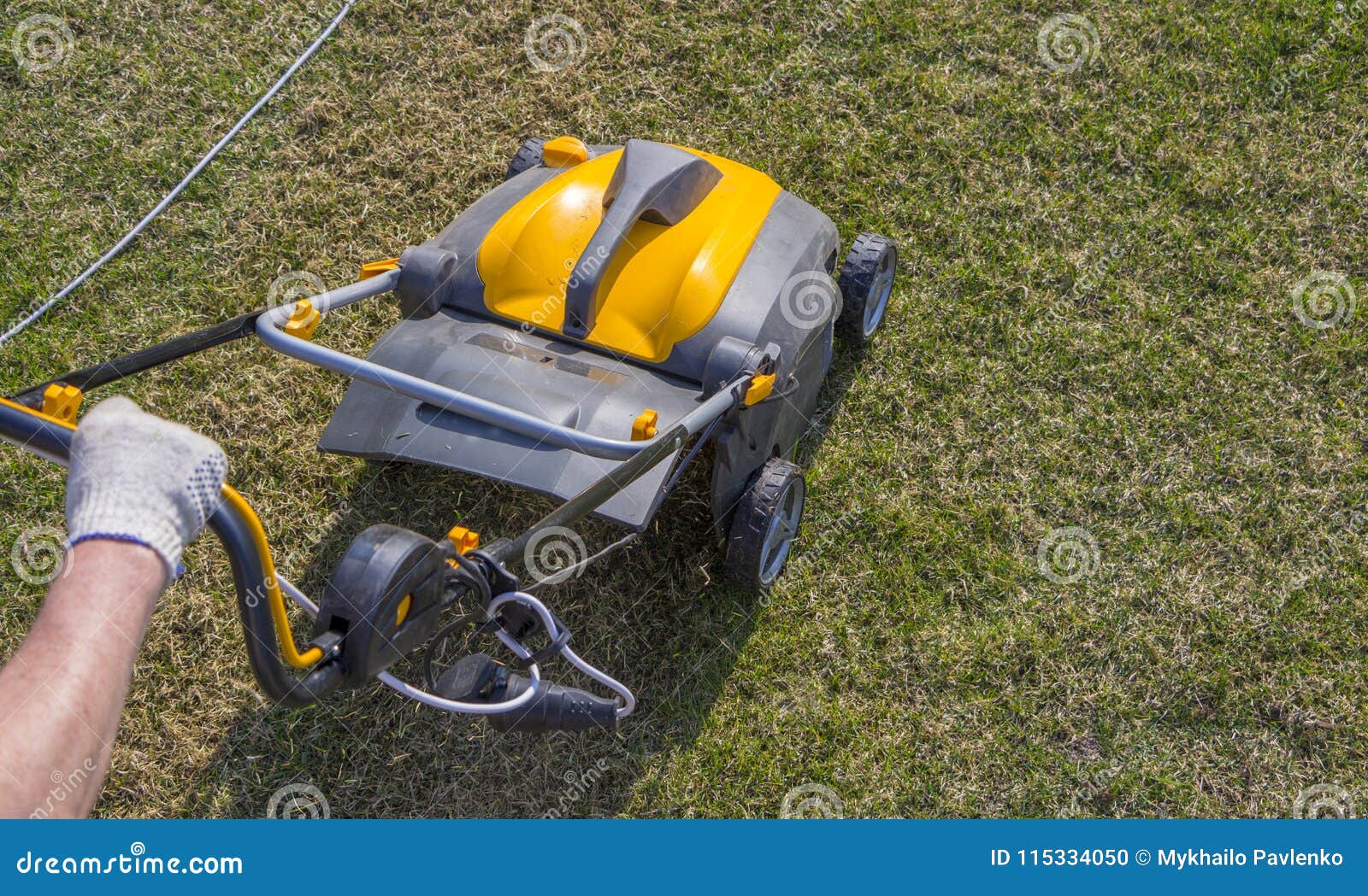 Gardener Operating Soil Aeration Machine on Grass Lawn Stock Photo